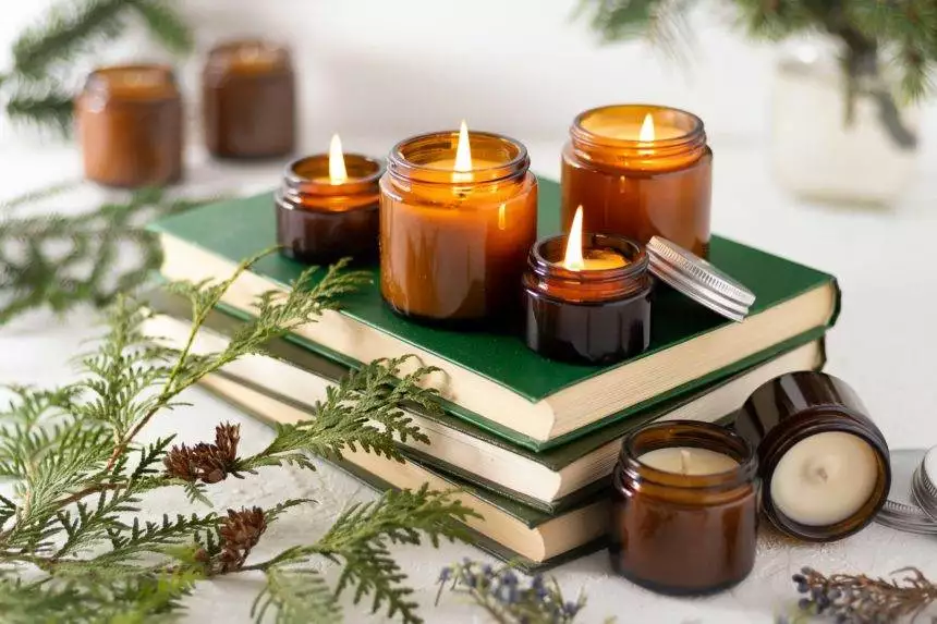 A set of different aroma candles in glass jars on a white background. Scented handmade candle. Soy