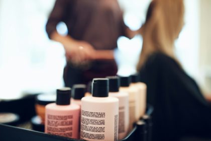 Bottles of styling products in a hair salon