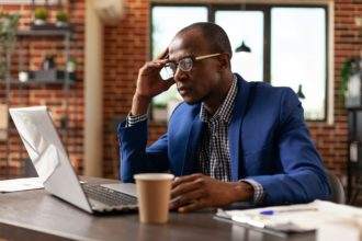 Business man brainstorming solution and working with laptop on marketing strategy