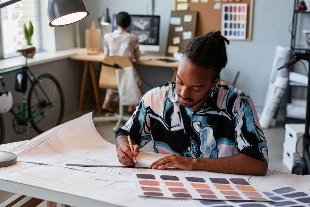 Man working on floor plans for interior design