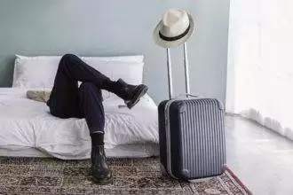 Portrait of young asian man traveler prepare suitcase for holiday vacation.