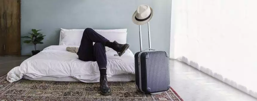 Portrait of young asian man traveler prepare suitcase for holiday vacation.